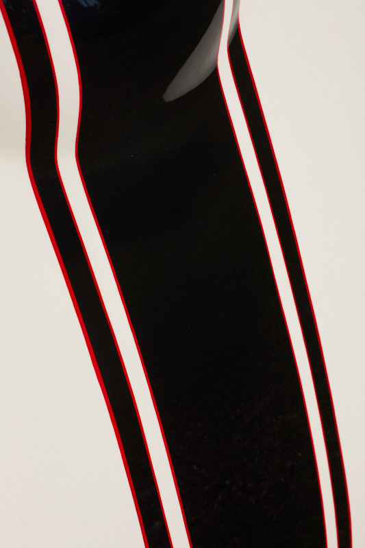 Black racing stripes edged in red running over white bodywork