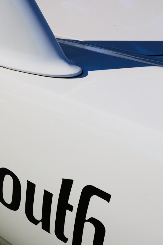 Blue stripe and painted lettering on a white racing body