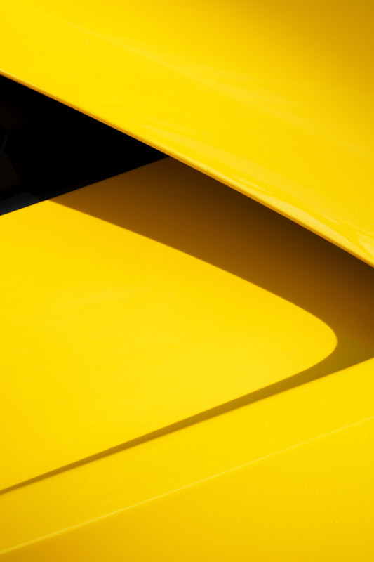Curved shadow falling across a yellow air intake