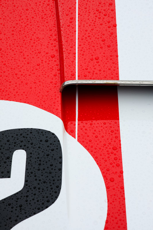 Number 9 racing livery in red and white, beaded with water